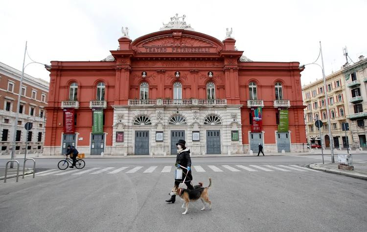 Coronavirus, Italia, mujer sola en la calle con perro, Reuters