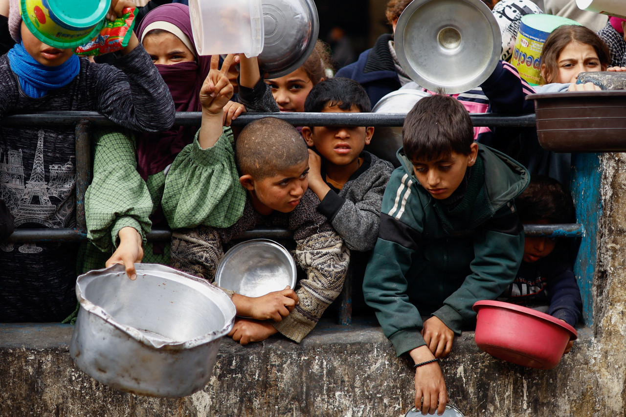 Niños en campo de refugiados en Rafah, Gaza, pidiendo comida. Foto: Reuters.